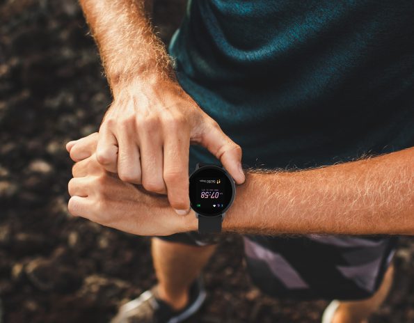 Athletic man using fitness tracker or smart watch